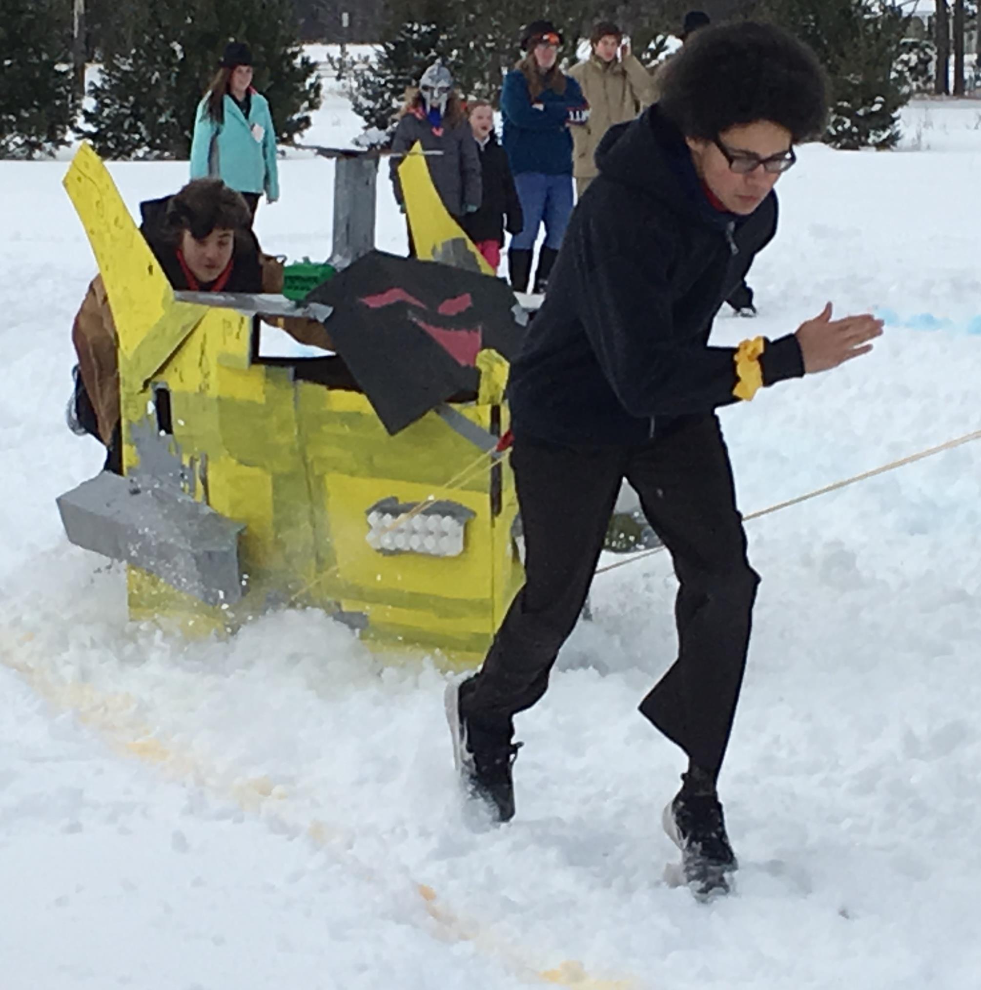 Students participating in cardboard sled race.